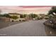 An inviting gated driveway entrance showcasing beautiful desert landscaping and charming curb appeal at 2727 S Balboa Dr, Gilbert, AZ 85295