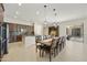 Spacious open kitchen with an island and long dining table with seating for ten under decorative lighting at 2727 S Balboa Dr, Gilbert, AZ 85295