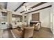 The living room is decorated with hardwood floors, wood ceiling beams, and stylish neutral furniture at 2727 S Balboa Dr, Gilbert, AZ 85295