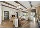 Bright living room features a fireplace, wooden beam ceiling, and a large window overlooking the backyard at 2727 S Balboa Dr, Gilbert, AZ 85295