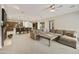 Open living room with a cozy fireplace, large sectional couch, and an adjacent kitchen and dining area at 2727 S Balboa Dr, Gilbert, AZ 85295