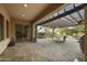 Outdoor living space with pergola, stone fireplace, dining table, and a landscaped backyard at 2727 S Balboa Dr, Gilbert, AZ 85295