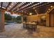 Charming patio with string lights, a ceiling fan, an outdoor dining table and a grill at 2727 S Balboa Dr, Gilbert, AZ 85295