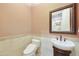 Charming powder room with pedestal sink, decorative mirror, and stylish tile accents at 2727 S Balboa Dr, Gilbert, AZ 85295