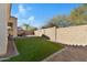 Well-maintained backyard with artificial grass and block wall fencing for privacy at 29798 N 121St Dr, Peoria, AZ 85383