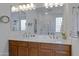 Bathroom featuring double sink with wood cabinets and towel racks at 29798 N 121St Dr, Peoria, AZ 85383