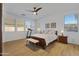 Bedroom featuring multiple windows, ceiling fan, and treadmill for exercise at 29798 N 121St Dr, Peoria, AZ 85383