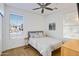 Bedroom with wood floors, ceiling fan, and bright natural light at 29798 N 121St Dr, Peoria, AZ 85383