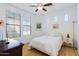Well lit bedroom with wood floors, fan, and large windows at 29798 N 121St Dr, Peoria, AZ 85383
