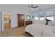 Bright bedroom with hardwood floors, ceiling fan, and traditional wood furniture set with a walk-in closet at 29798 N 121St Dr, Peoria, AZ 85383