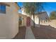 Charming single-story home features a landscaped front yard, a terracotta roof and a pink entrance door at 29798 N 121St Dr, Peoria, AZ 85383