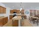 Open kitchen features granite countertops, a center island and a stainless steel microwave at 29798 N 121St Dr, Peoria, AZ 85383