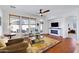 Open-concept living room with a fireplace and a view into the backyard at 29798 N 121St Dr, Peoria, AZ 85383
