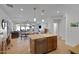 Open-concept living area features bright lighting, views to dining and kitchen, with a fireplace at 29798 N 121St Dr, Peoria, AZ 85383