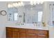 Dual sink bathroom vanity with a large mirror and views of the shower and bathtub at 29798 N 121St Dr, Peoria, AZ 85383
