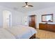 Bright main bedroom features wood floors, a ceiling fan, and matching wood furniture at 29798 N 121St Dr, Peoria, AZ 85383