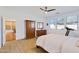 Bright main bedroom features wood floors, a ceiling fan, and large windows at 29798 N 121St Dr, Peoria, AZ 85383