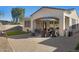 Inviting covered patio with outdoor seating, dining set and blue umbrella at 29798 N 121St Dr, Peoria, AZ 85383