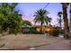 Lush backyard with mature trees, a sparkling pool, and a charming covered patio area at 3146 W Paradise Dr, Phoenix, AZ 85029