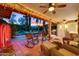 Relaxing covered backyard patio with wicker furniture, string lights, and views of the pool at 3146 W Paradise Dr, Phoenix, AZ 85029