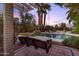 Relaxing backyard retreat with a pool, a swing, and swaying palm trees for peaceful outdoor living at 3146 W Paradise Dr, Phoenix, AZ 85029