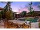 Outdoor dining area overlooking a stunning pool with a waterfall feature, creating a serene atmosphere at 3146 W Paradise Dr, Phoenix, AZ 85029