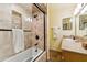 A remodeled bathroom with a tiled shower and granite countertop vanity at 3146 W Paradise Dr, Phoenix, AZ 85029
