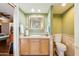 Well-maintained bathroom featuring a sink with wood cabinets, a toilet, neutral wall colors and tile flooring at 3146 W Paradise Dr, Phoenix, AZ 85029