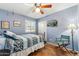 Bright bedroom with a twin bed, ceiling fan, natural light and modern decor creating a cozy space at 3146 W Paradise Dr, Phoenix, AZ 85029