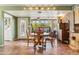 Cozy dining area with a large window, wooden table, and easy access to the kitchen at 3146 W Paradise Dr, Phoenix, AZ 85029