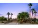 Charming single-story home with desert landscaping and mature palm trees at dusk at 3146 W Paradise Dr, Phoenix, AZ 85029