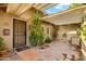 Inviting front entryway with a tiled patio, mature plants, and a charming fountain at 3146 W Paradise Dr, Phoenix, AZ 85029