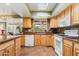 Functional kitchen with warm-toned cabinets, a window over the sink, and modern appliances at 3146 W Paradise Dr, Phoenix, AZ 85029