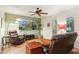 Spacious living room with a ceiling fan, comfortable seating, a media center, and natural lighting at 3146 W Paradise Dr, Phoenix, AZ 85029