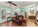 Comfortable living room with a ceiling fan, tile floors, and a cozy seating area at 3146 W Paradise Dr, Phoenix, AZ 85029