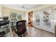 Bright home office featuring a glass desk, comfortable chair, tiled floor, and access to the outdoors at 3146 W Paradise Dr, Phoenix, AZ 85029