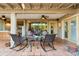 Covered patio with rocking chairs and a glass table at 3146 W Paradise Dr, Phoenix, AZ 85029