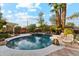 A backyard pool features a waterfall and mature landscaping at 3146 W Paradise Dr, Phoenix, AZ 85029
