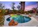 Backyard pool area with landscaping and mature trees at dusk at 3146 W Paradise Dr, Phoenix, AZ 85029