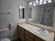 Well-lit bathroom with a vanity, sink, mirror, and toilet at 3420 W Danbury Dr # C218, Phoenix, AZ 85053