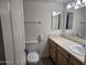 Well-lit bathroom with a vanity, sink, mirror, and toilet at 3420 W Danbury Dr # C218, Phoenix, AZ 85053