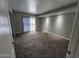 Comfortable bedroom with plush carpeting, sliding glass door to balcony, and recessed ceiling lights at 3420 W Danbury Dr # C218, Phoenix, AZ 85053