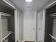 Hallway with white door and mirrored closet doors offering convenient storage solutions at 3420 W Danbury Dr # C218, Phoenix, AZ 85053