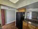 Open kitchen area with wooden floor and granite countertops; features access to the living room and refrigerator at 3420 W Danbury Dr # C218, Phoenix, AZ 85053