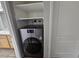 Convenient laundry space with a modern washer and dryer unit, complemented by built-in shelving at 3420 W Danbury Dr # C218, Phoenix, AZ 85053
