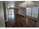 Bright living room with tray ceiling, hardwood floors, and sliding door access to the outside at 3420 W Danbury Dr # C218, Phoenix, AZ 85053