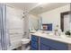 Bright bathroom featuring a shower-tub combo and blue vanity with white countertops at 3830 E Lakewood Pkwy # 1057, Phoenix, AZ 85048