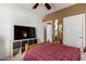 Bedroom with ceiling fan and TV, offering convenient storage solutions at 3830 E Lakewood Pkwy # 1057, Phoenix, AZ 85048