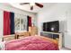 Comfortable bedroom with ceiling fan, large window and desk and dresser at 3830 E Lakewood Pkwy # 1057, Phoenix, AZ 85048