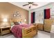 Relaxing bedroom featuring a wood bed frame, soft carpet, and a simple yet stylish décor at 3830 E Lakewood Pkwy # 1057, Phoenix, AZ 85048